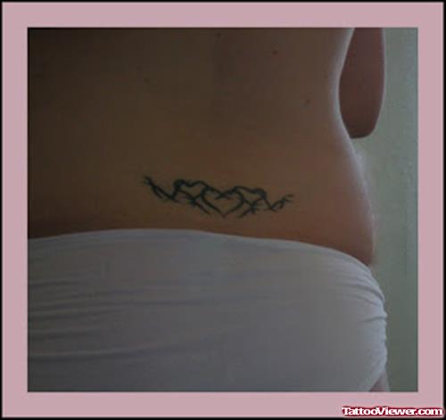 Tribal And Heart Tattoos on Girl Lowerback