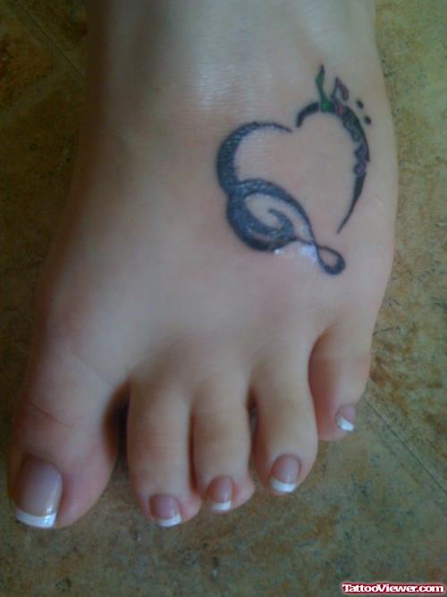 Black Ink Tribal Heart Tattoo On Left Foot