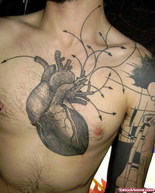 Grey Ink Real Heart Tattoo On Man Chest