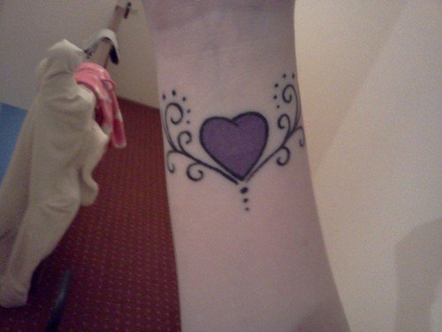 Purple Ink Heart Tattoo On Wrist
