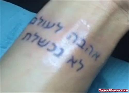 Amazing Black Ink Hebrew Tattoo On Left Wrist