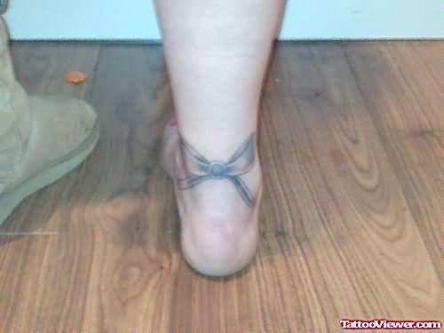 Grey Ink Bow Heel Tattoo
