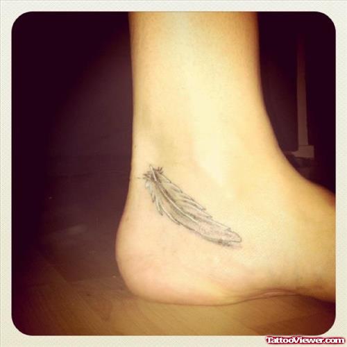 Grey Ink Feather Heel Tattoo