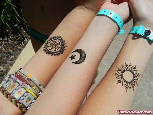 Sun, Moon And Henna Tattoos On Forearm