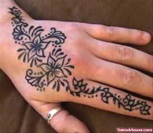 Henna Flowers And Tribal Tattoo On Left Hand