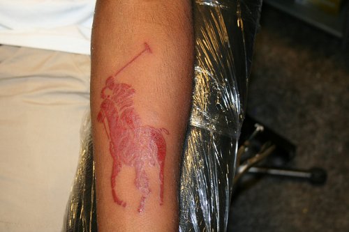Red Ink Horse Tattoo On Sleeve