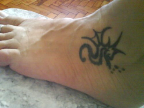 Black Tribal Sea Horse Tattoo On Left Foot