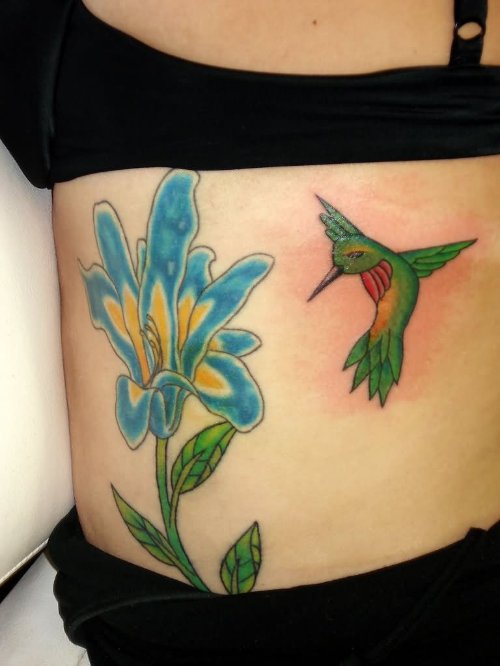 Blue Flower And Flying Hummingbird Tattoo