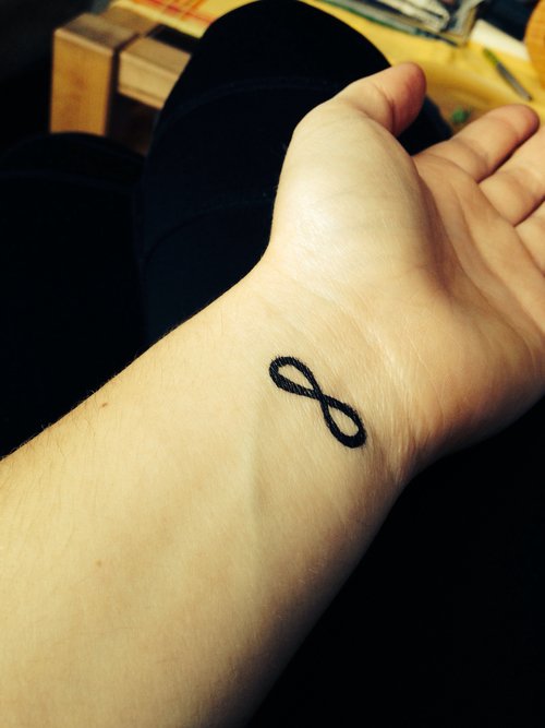 Black Ink Infinity Tattoo On Left Wrist