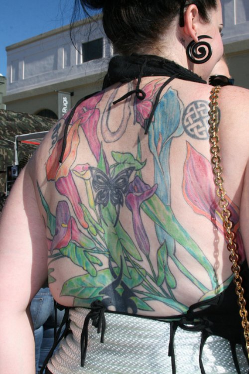 Colored Iris Tattoo On Girl Back