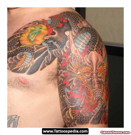 Colored Japanese Tattoo On Man Chest And Half Sleeve
