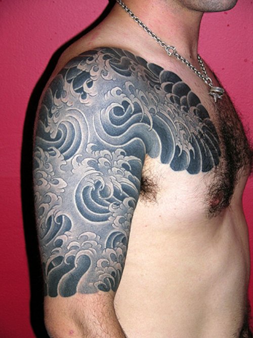Dark Ink Japanese Tattoo On Man Chest And Right Half Sleeve