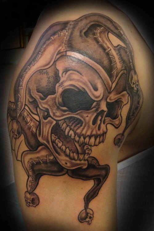 Grey Ink Jester Skull Tattoo on Shoulder