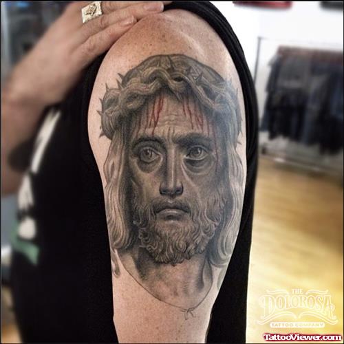Grey Ink Jesus Tattoo On Left Biceps
