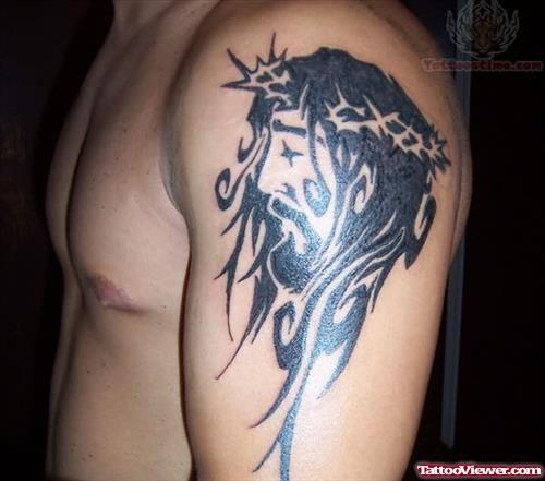Black Ink Tribal Jesus Tattoo On Man Left Shoulder
