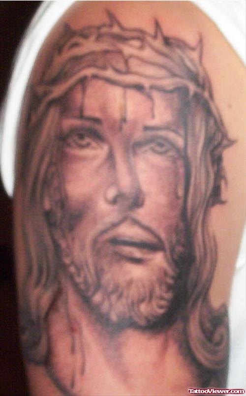 Attractive Grey Ink Jesus Head Tattoo On Right Shoulder