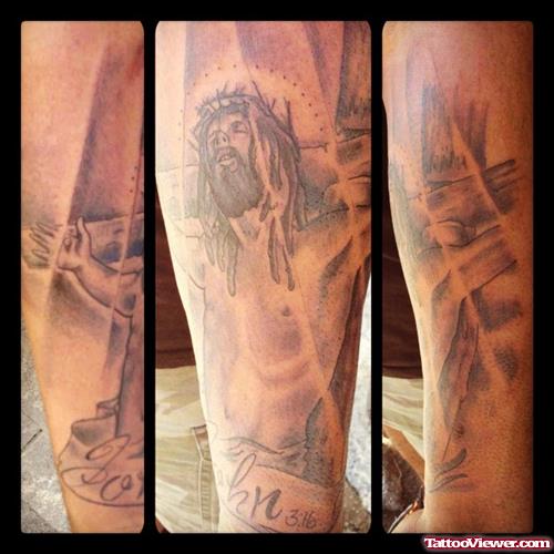 Grey Ink Cross And Jesus Tattoo On Sleeve