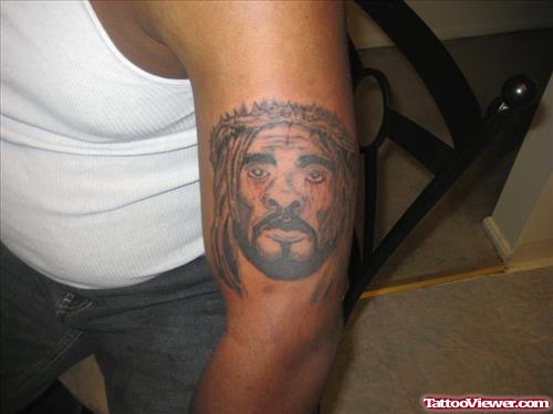 Grey Ink Jesus Head Tattoo On Man Left Bicep