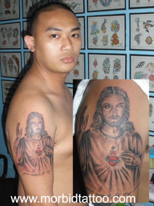 Grey Ink Jesus Tattoo On Right Bicep