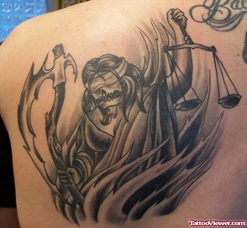 Grey Ink Justice Tattoo On Left Back Shoulder