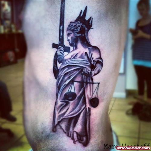 Grey Ink Justice Tattoo On Man Left Side Rib
