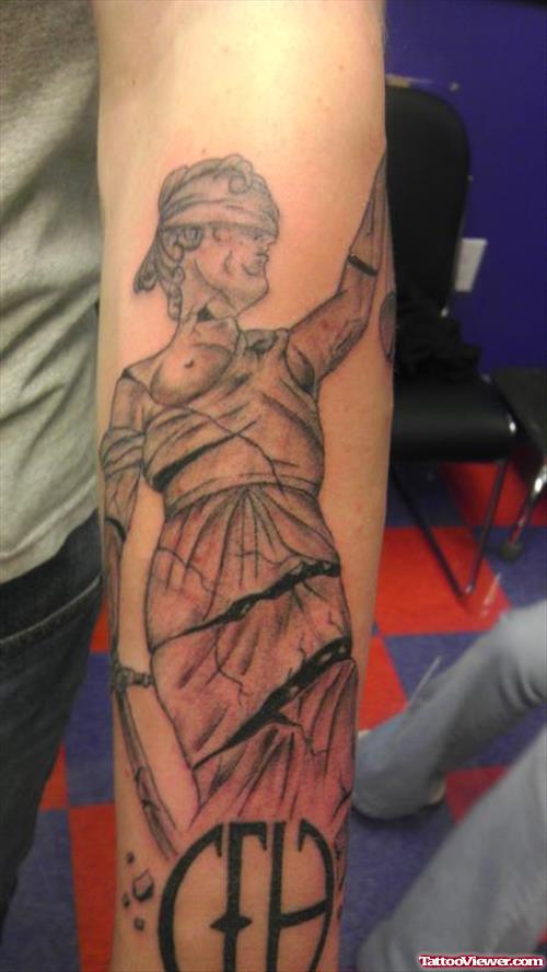 Amazing Grey Ink Justice Tattoo On Left Sleeve