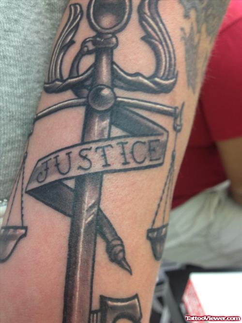 Grey Ink Justice Tattoo On Sleeve