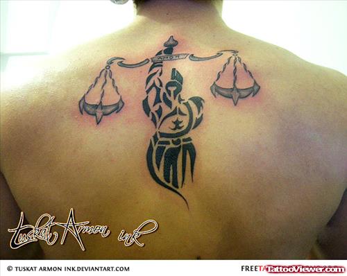 Tribal Justice Tattoo On Man Upperback