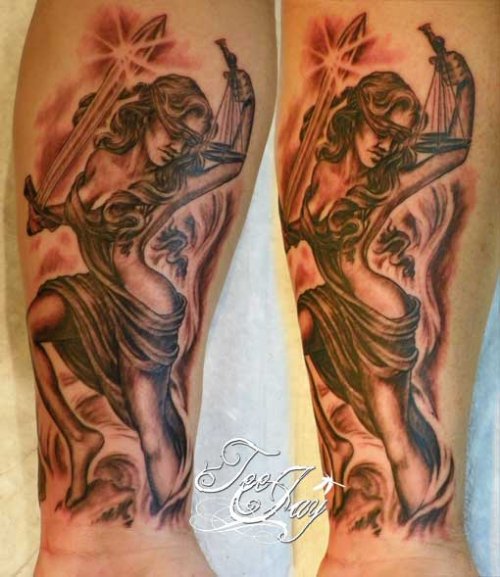Grey Ink Justice Tattoo On Forearm