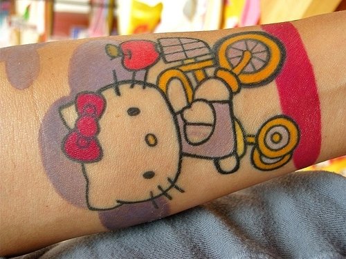 Awesome Color Kitty On Bicycle Tattoo On Arm
