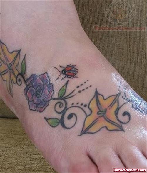 Flowers, Leaves, and Ladybug Tattoo