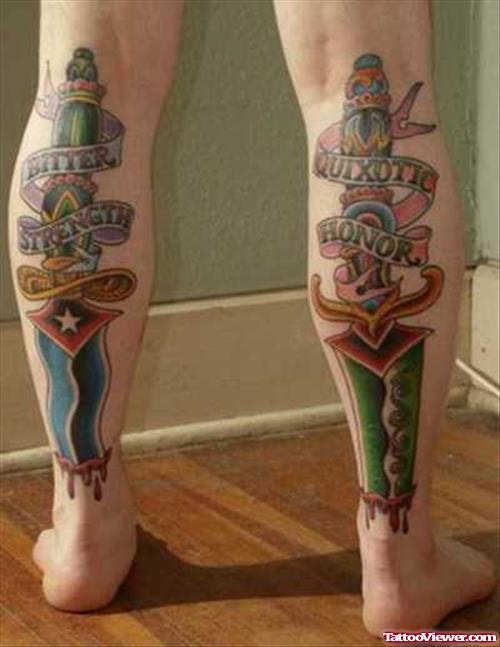 Colored Ink Back Leg Daggers Tattoo