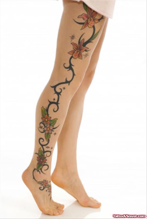 Tribal And Colored Flowers Leg Tattoo