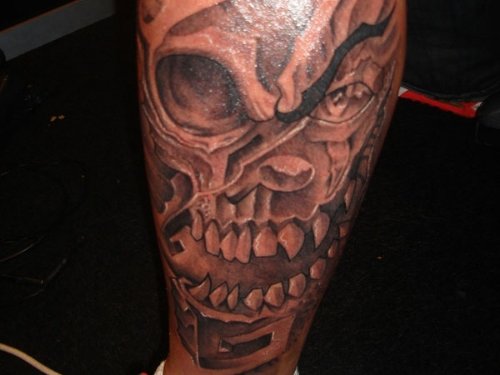 Attractive Grey Ink Skull Leg Tattoo