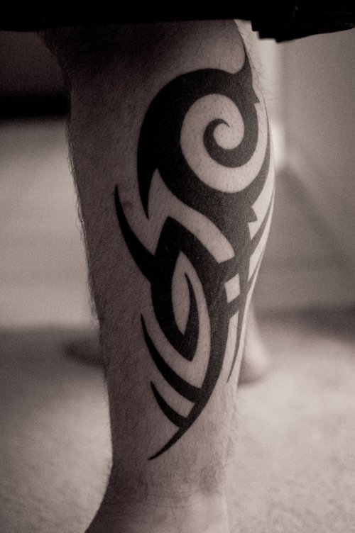 Wonderful Black Ink Tribal Leg Tattoo