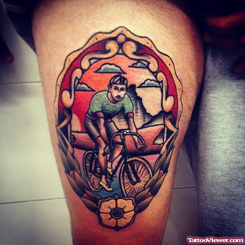 man on bicycle tattoo on leg