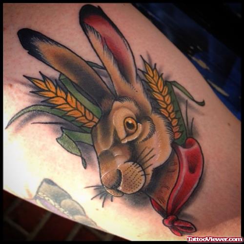 rabbit with red tie in wheat tattoo on leg