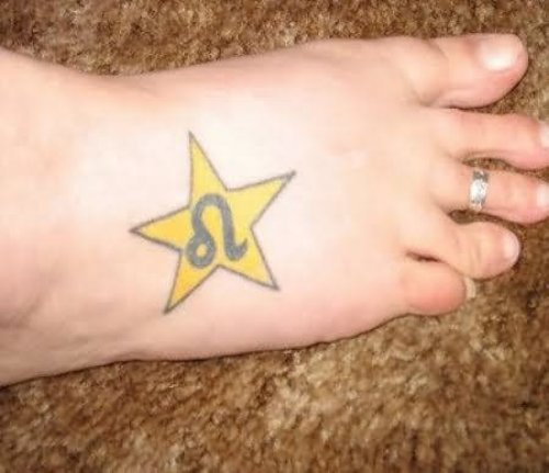 Yellow Star With Leo Sign Tattoo On Foot