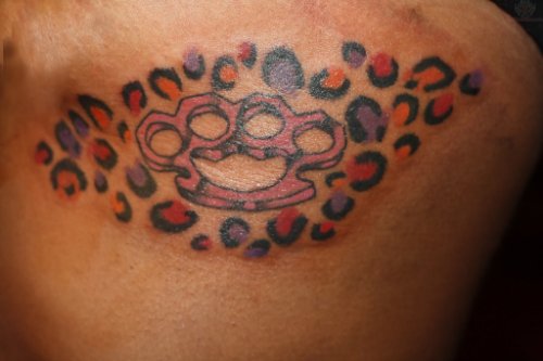 Knuckle And Leopard Print Tattoo On Side