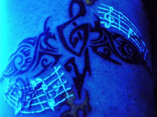 Tribal and Music Notes Light Tattoo