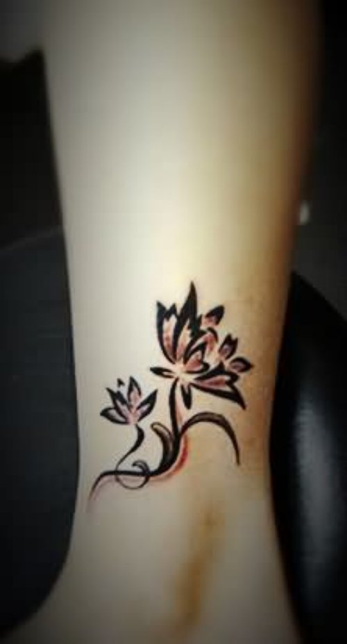Black Ink Tribal Lily Tattoo On Ankle