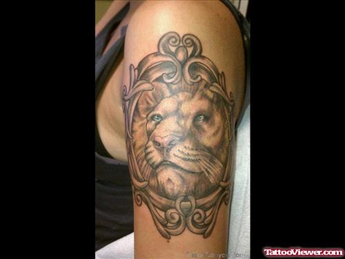 Grey Ink Lion Tattoo On Bicep
