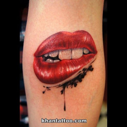 Biting Lips With Teeth Tattoo On Arm By Khan