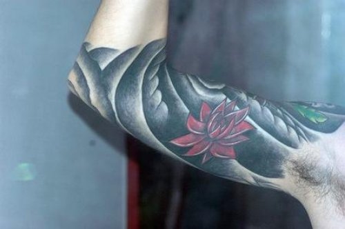 Guy With Lotus Flower Tattoo On Inner Bicep