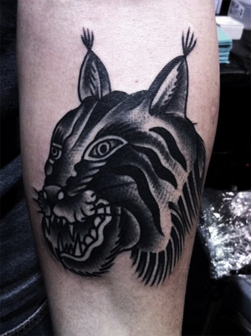 Black Ink Lynx Head Tattoo On Arm