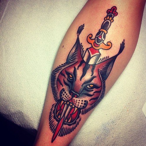Dagger and Lynx Head Tattoo on Arm