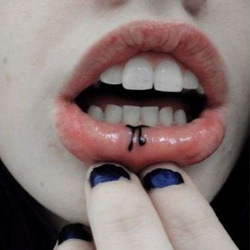 Small Pi Black Ink Tattoo On Girl Lower Lip