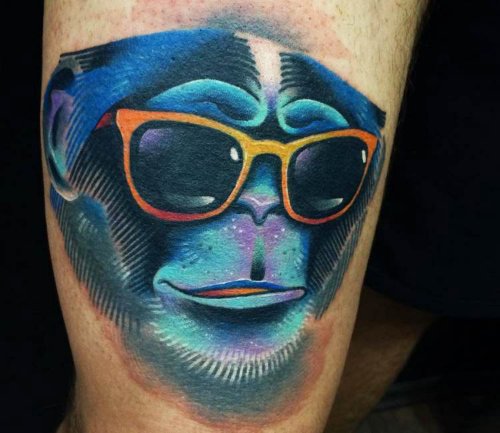 Blue Ink Monkey Head Tattoo On Bicep