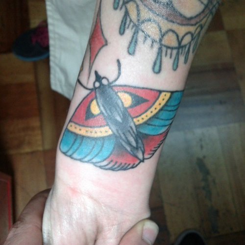 Color Ink Moth Tattoo On Right Wrist