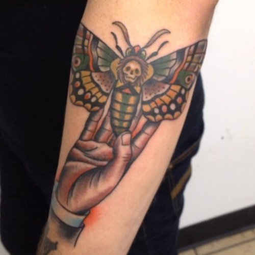 Moth in Hand Tattoo on Arm